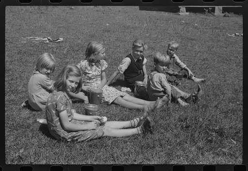 Untitled photo, possibly related to: Child eating lunch during the noon hour at school in Breathitt County, Kentucky. In his lunch pail were cold potatoes, corn bread and mush
