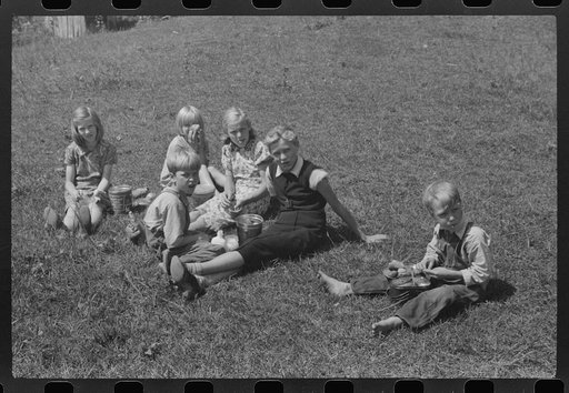 Untitled photo, possibly related to: Child eating lunch during the noon hour at school in Breathitt County, Kentucky. In his lunch pail were cold potatoes, corn bread and mush
