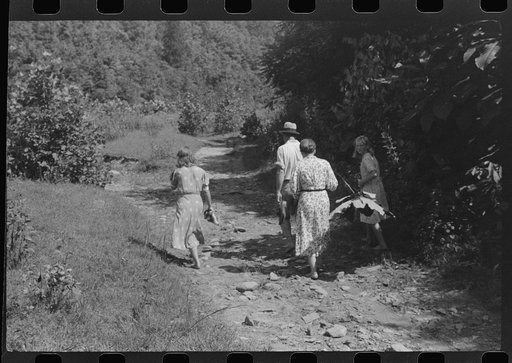 Untitled photo, possibly related to: Mountain people carrying a homemade coffin up creek bed to the family plot on the hillside where it will be buried. This section is too isolated to hold any formal funeral services immediately. Up South Fork of the Kentucky River near Jackson, Kentucky