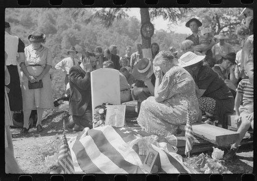 Mother and relatives weeping at the grave of deceased at memorial meeting. Preacher, with hands over ears, is praying. Near Jackson, Breathitt County, Kentucky. See general caption no. 1