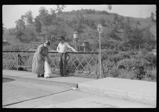 Jackson, Kentucky. A mountain woman chatting with a friend on the bridge in Jackson.