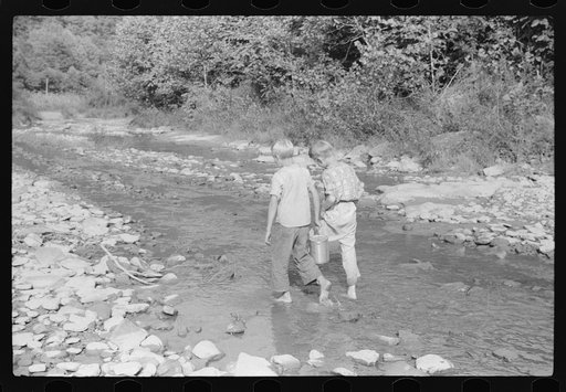 Going home from school. In Breathitt County, Kentucky. The school year begins in July and ends in January as most of the children have no shoes and insufficient clothing to walk the long distances over bad roads and up creek beds