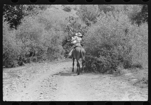 Untitled photo, possibly related to: Going home from school. In Breathitt County, Kentucky. The school year begins in July and ends in January as most of the children have no shoes and insufficient clothing to walk the long distances over bad roads and up creek beds