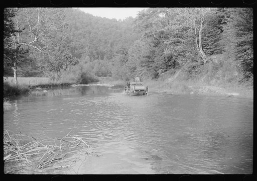 Untitled photo, possibly related to: Going home from school. In Breathitt County, Kentucky. The school year begins in July and ends in January as most of the children have no shoes and insufficient clothing to walk the long distances over bad roads and up creek beds