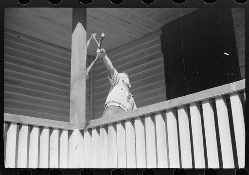 Untitled photo, possibly related to: Mountain child shooting slingshot from porch of his home. Near Buckhorn, Kentucky
