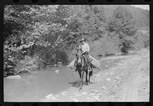 Rural mailman going up the creek bed toward Morris Fork near Jackson, Kentucky