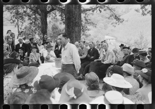Untitled photo, possibly related to: Preacher, relatives and friends of the deceased at a memorial meeting near Jackson, Breathitt County, Kentucky. See general caption no. 1