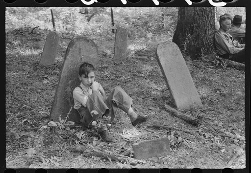 Untitled photo, possibly related to: Son of one of the deceased's family at an annual memorial meeting in the family cemetery. In the mountains near Jackson, Kentucky. See general caption no. 1