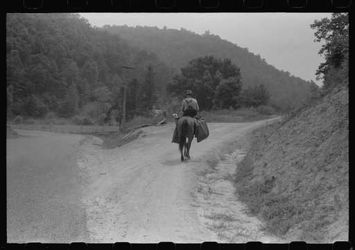 Rural postman who delivers mail to the mountain families up the side roads and creek beds. Near Jackson, Kentucky