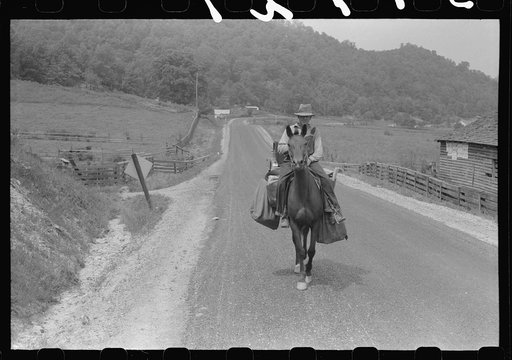 Rural postman who delivers mail to the mountain families up the side roads and creek beds. Near Jackson, Kentucky
