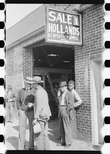 Farmers waiting outside of warehouse during tobacco auction sale. Danville, Virginia