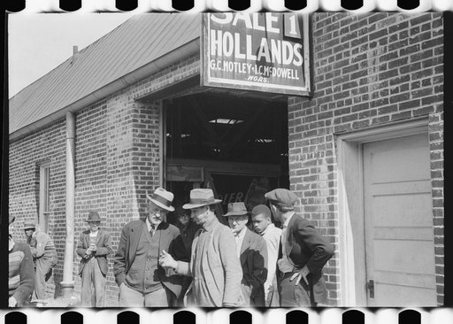 Untitled photo, possibly related to: Farmers waiting outside of warehouse during tobacco auction sale. Danville, Virginia
