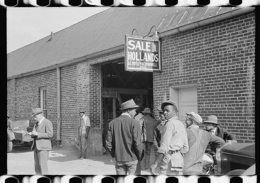 Untitled photo, possibly related to: Farmers waiting outside of warehouse during tobacco auction sale. Danville, Virginia