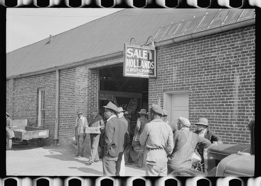 Farmers waiting outside of warehouse during tobacco auction sale. Danville, Virginia