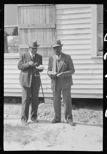 Untitled photo, possibly related to: Outdoor picnic during the noon intermission of an all-day ministers and deacons meeting. Near Yanceyville, Caswell County, North Carolina