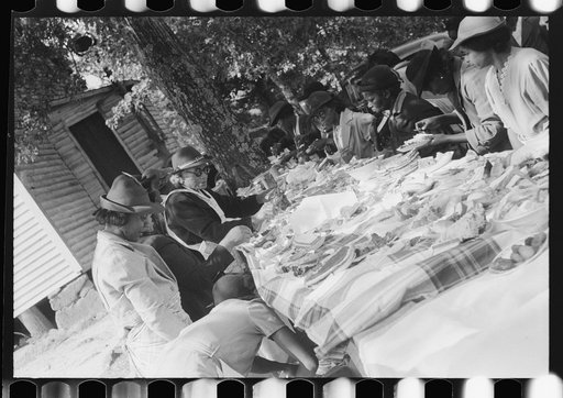 Untitled photo, possibly related to: Outdoor picnic during the noon intermission of an all-day ministers and deacons meeting. Near Yanceyville, Caswell County, North Carolina