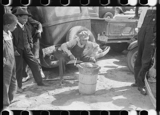 Children making ice cream to be sold for the benefit of the church at a ministers and deacons meeting near Yanceyville, Caswell County, North Carolina
