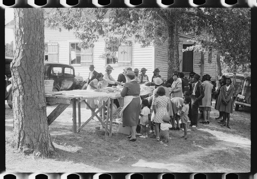Untitled photo, possibly related to: Outdoor picnic during the noon intermission of an all-day ministers and deacons meeting. Near Yanceyville, Caswell County, North Carolina