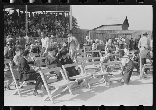 Untitled photo, possibly related to: Yanceyville, North Carolina. Spectators listening to the county school superintendent speaking at the Caswell County Fair