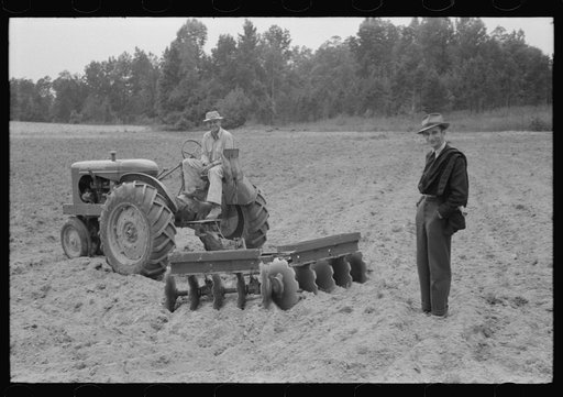 Untitled photo, possibly related to: Connie B. Gay, FSA (Farm Security Administration) county supervisor talking to Emery Hooper about his tractor and disc plow purchased with a FSA cooperative community service loan. Near Prospect Hill, Caswell County, North Carolina