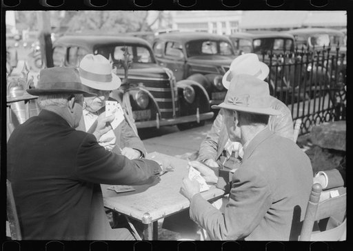 Members of the community playing cards in front of the courthouse, Yanceyville, Caswell County, North Carolina