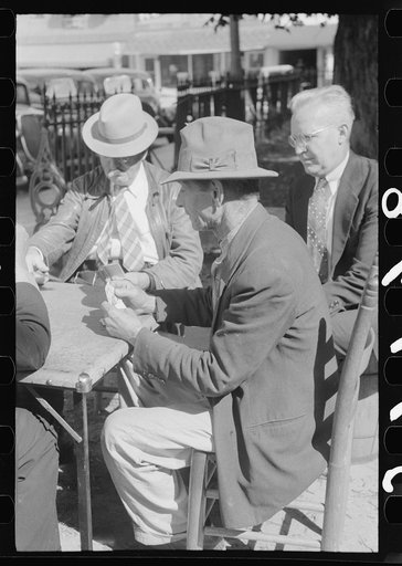 Untitled photo, possibly related to: Members of the community playing cards in front of the courthouse, Yanceyville, Caswell County, North Carolina