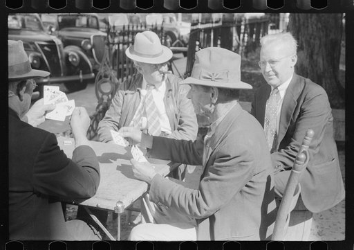 Untitled photo, possibly related to: Members of the community playing cards in front of the courthouse, Yanceyville, Caswell County, North Carolina