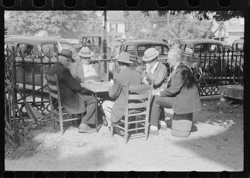 Untitled photo, possibly related to: Members of the community playing cards in front of the courthouse, Yanceyville, Caswell County, North Carolina