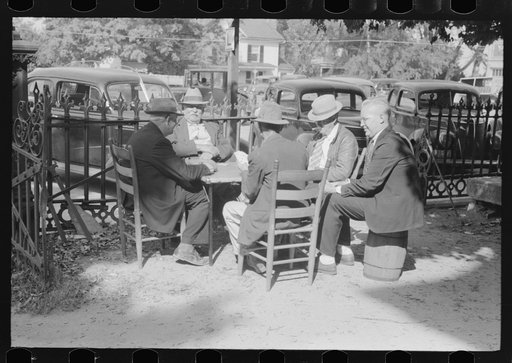 Untitled photo, possibly related to: Members of the community playing cards in front of the courthouse, Yanceyville, Caswell County, North Carolina