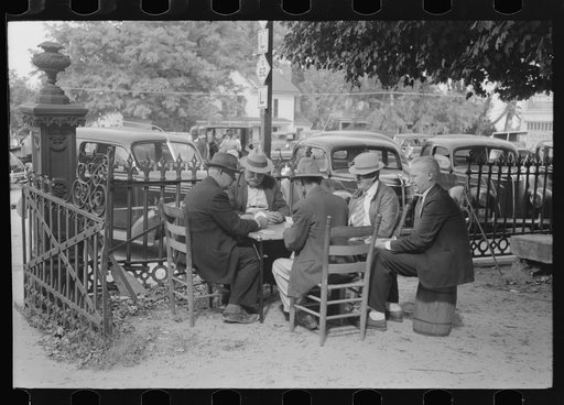 Members of the community playing cards in front of the courthouse, Yanceyville, Caswell County, North Carolina