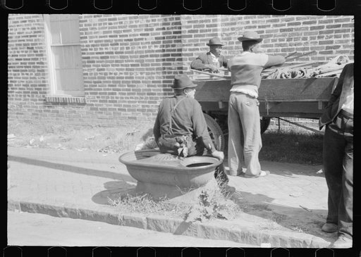 Untitled photo, possibly related to: Taking a load of tobacco into the warehouse for the auction sale. Danville, Virginia