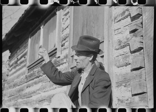 Noah Garland sitting on the steps of his son's home, Southern Appalachian Project, near Barbourville, Knox County, Kentucky