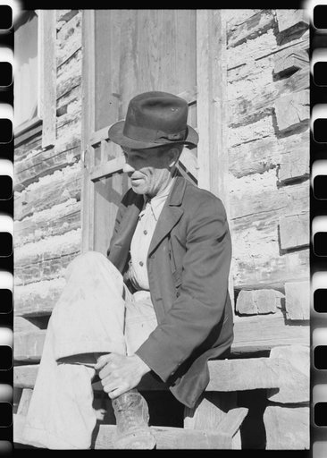 Noah Garland sitting on the steps of his son's home, Southern Appalachian Project, near Barbourville, Knox County, Kentucky