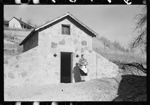 Mrs. S. Castle or Mrs. William S. Allen with canned goods in front of new storage house her husband built on their farm with FSA (Farm Security Administration) help. Southern Appalachian project, near Barbourville, Knox County, Kentucky