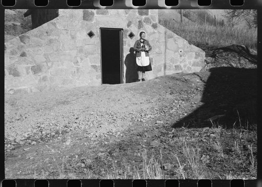 Untitled photo, possibly related to: Mrs. S. Castle or Mrs. William S. Allen with canned goods in front of new storage house her husband built on their farm with FSA (Farm Security Administration) help. Southern Appalachian project, near Barbourville, Knox County, Kentucky