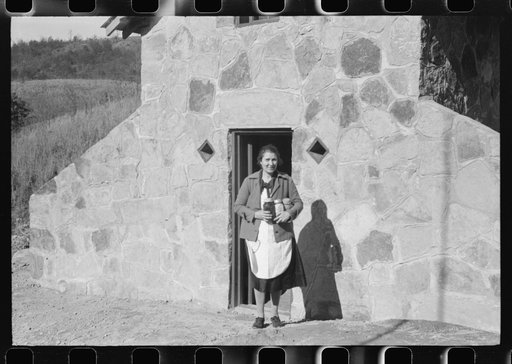 Untitled photo, possibly related to: Mrs. S. Castle or Mrs. William S. Allen with canned goods in front of new storage house her husband built on their farm with FSA (Farm Security Administration) help. Southern Appalachian project, near Barbourville, Knox County, Kentucky