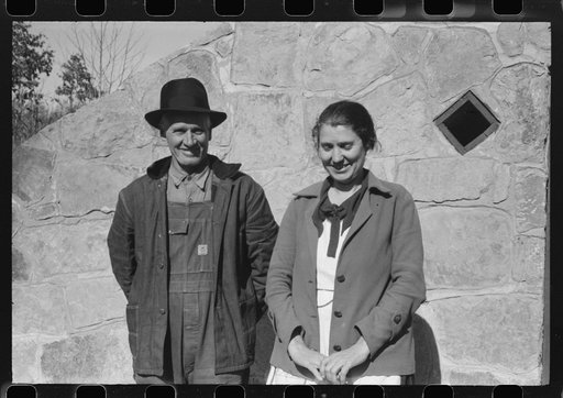 Untitled photo, possibly related to: Mr. and Mrs. S. Castle or Mr. and Mrs. William S. Allen standing before their new storage house. Southern Appalachian Project, near Barbourville, Knox County, Kentucky. Mr. and Mrs. S.W. Castle, in front of his new storage house her husband built on their farm, w