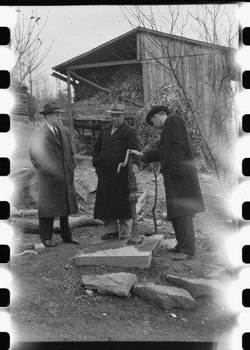 Untitled photo, possibly related to: Dr. R.B. Fulks, county health officer, John E. Hale, contractor and builder of sanitary units, and B.H. Pitt, inspector of sanitary units, making a sanitation inspection on the farm of Hobert Hammons, FSA (Farm Security Administration) borrower. Southern Appalach