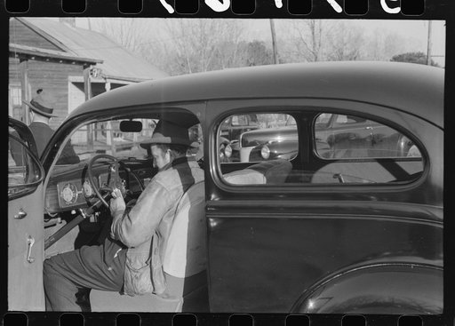 Untitled photo, possibly related to: Spanish trappers and fur buyers waiting around while muskrats are being graded during auction sale on porch of community store, St. Bernard, Louisiana