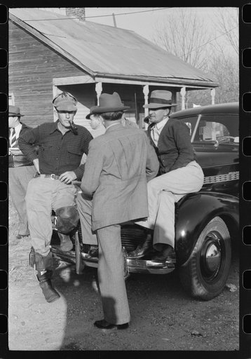 Untitled photo, possibly related to: Spanish trappers and fur buyers waiting around while muskrats are being graded during auction sale on porch of community store, St. Bernard, Louisiana