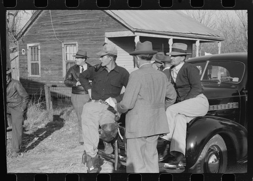 Untitled photo, possibly related to: Spanish trappers and fur buyers waiting around while muskrats are being graded during auction sale on porch of community store, St. Bernard, Louisiana