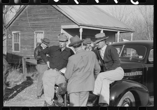 Untitled photo, possibly related to: Spanish trappers and fur buyers waiting around while muskrats are being graded during auction sale on porch of community store, St. Bernard, Louisiana