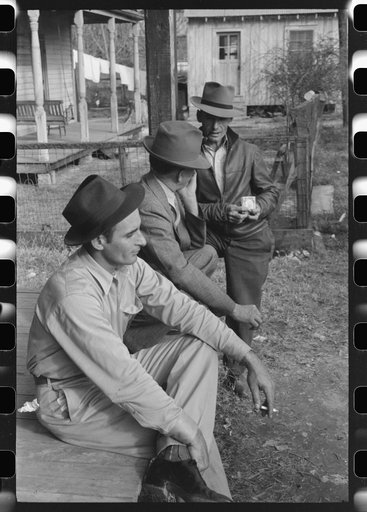 Untitled photo, possibly related to: Spanish trappers and fur buyers waiting around while muskrats are being graded during auction sale on porch of community store, St. Bernard, Louisiana
