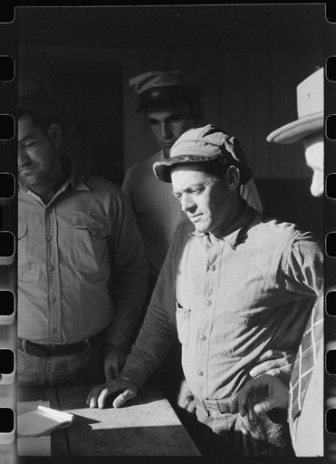 Untitled photo, possibly related to: Spanish trapper waiting for FSA (Farm Security Administration) supervisor to open the bids on the next "lot" of muskrats to be sold at auction held in dancehall on Delacroix Island, Louisiana