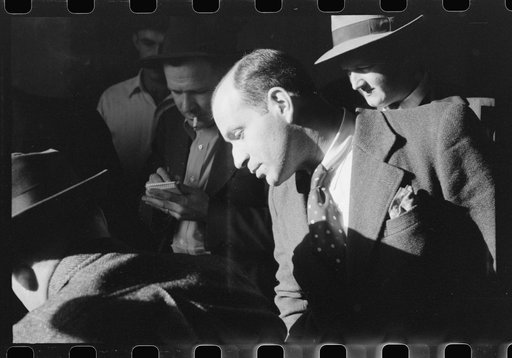 Untitled photo, possibly related to: Fur buyer from New Orleans waiting for FSA (Farm Security Administration) supervisor to open the bids at auction sale of muskrats in dancehall on Delacroix Island, Louisiana. See general caption no. 1