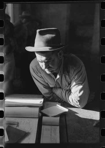 Fur buyer from New Orleans waiting for FSA (Farm Security Administration) supervisor to open the bids at auction sale of muskrats in dancehall on Delacroix Island,  Louisiana
