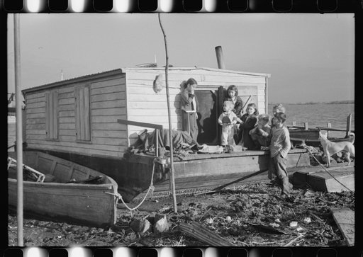 Untitled photo, possibly related to: Spanish trappers' children playing in front of their camp in the marshes near Delacroix Island, Louisiana. See general caption no. 1