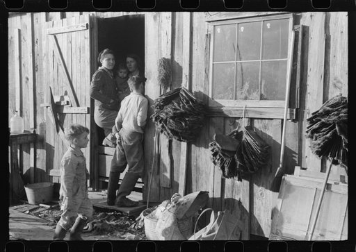 Spanish trapper's camp home and family with dried muskrat skins hanging in front. In the marshes near Delacroix Island, Louisiana. See general caption no. 1