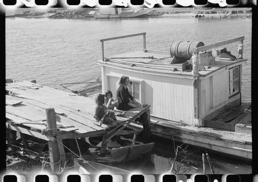 Untitled photo, possibly related to: Spanish trapper and his children taking muskrat pelts into the FSA (Farm Security Administration) auction sale which is held in a dancehall on Delacroix Island, Louisiana. The fur buyers come from New Orleans. See general caption no. 1