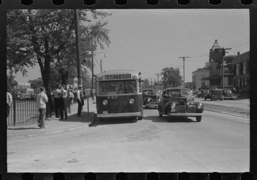 Buses which take many workers home in front of United Aircraft, Pratt and Whitney plant, East Hartford Connecticut
